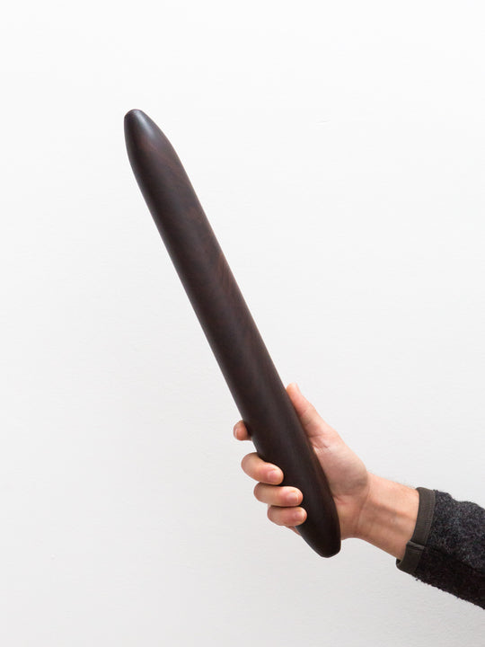 a deep chocolatey purple rosewood rolling pin